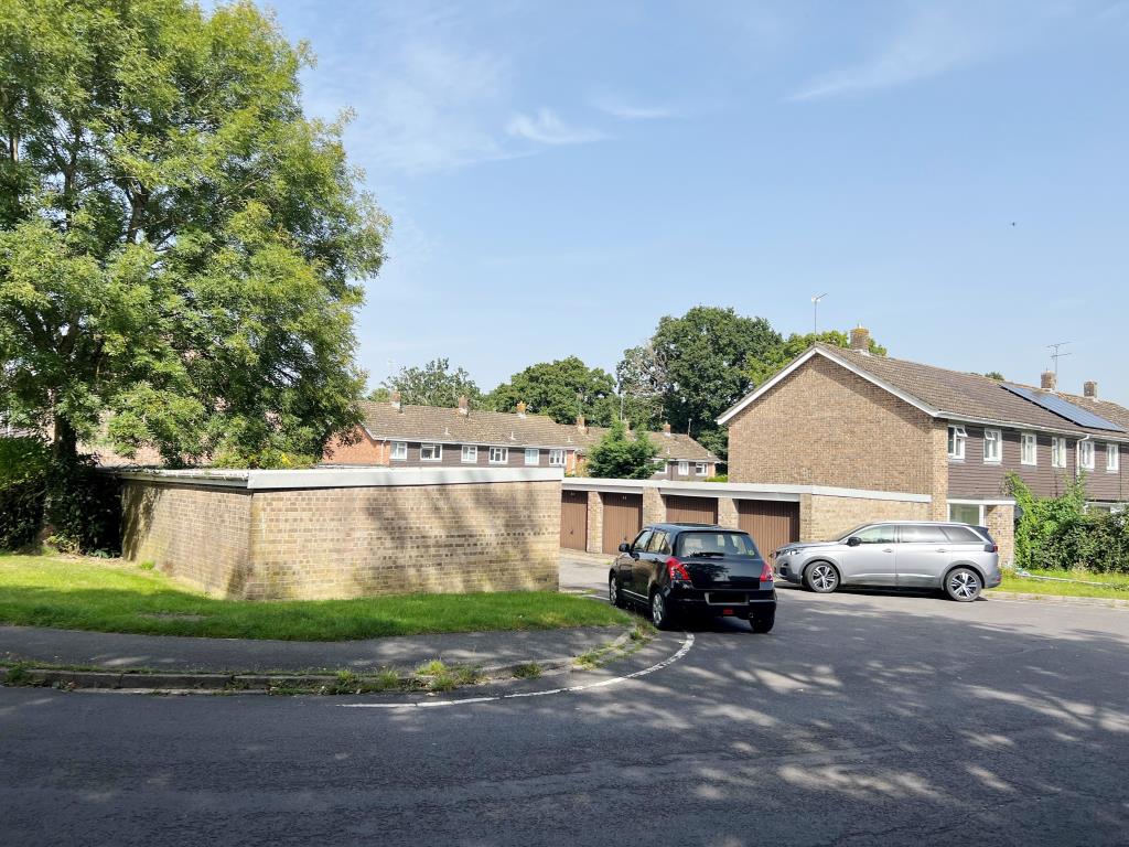 Lot: 49 - GARAGE COMPOUND WITH CONSENT FOR CONSTRUCTION OF TWO, THREE-BEDROOM HOUSES - Rear view of garage compound showing two blocks of garages of brick construction